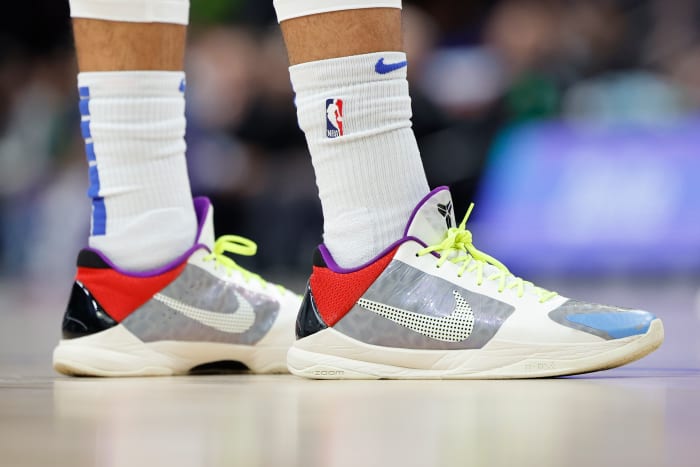View of Jalen Brunson's grey and red Nike Kobe 5 basketball shoes.